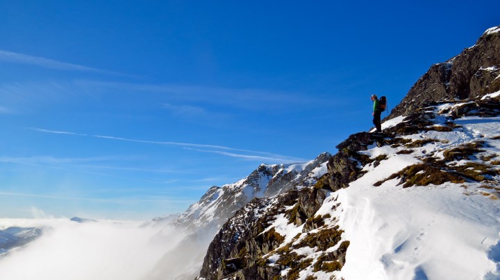 Annie standing above a glen full of mist.